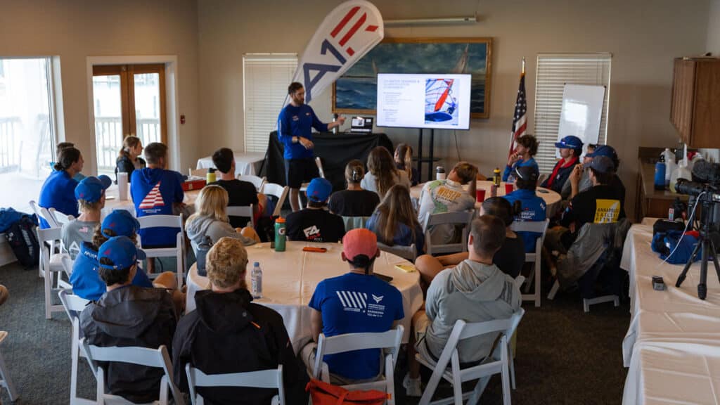 Foiling Team sitting inside around a table